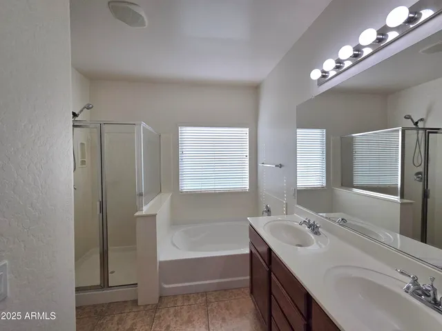 a bathroom with a shower and a tub