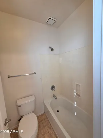 a bathroom with a toilet and a tub