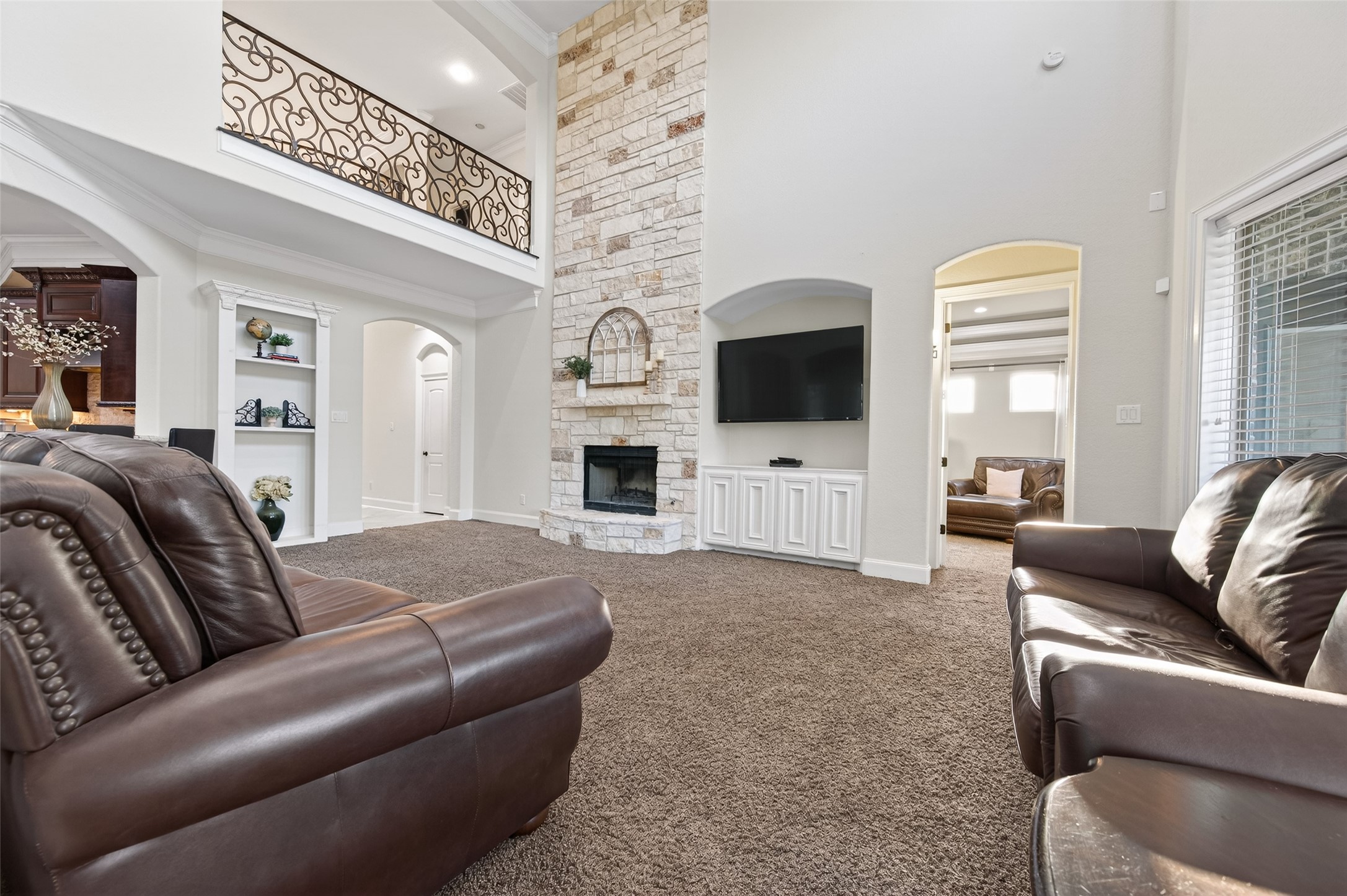 633 Crenshaw Road Houston, TX 77504 - Photo 13 of 50 a living room with furniture a flat screen tv and a fireplace