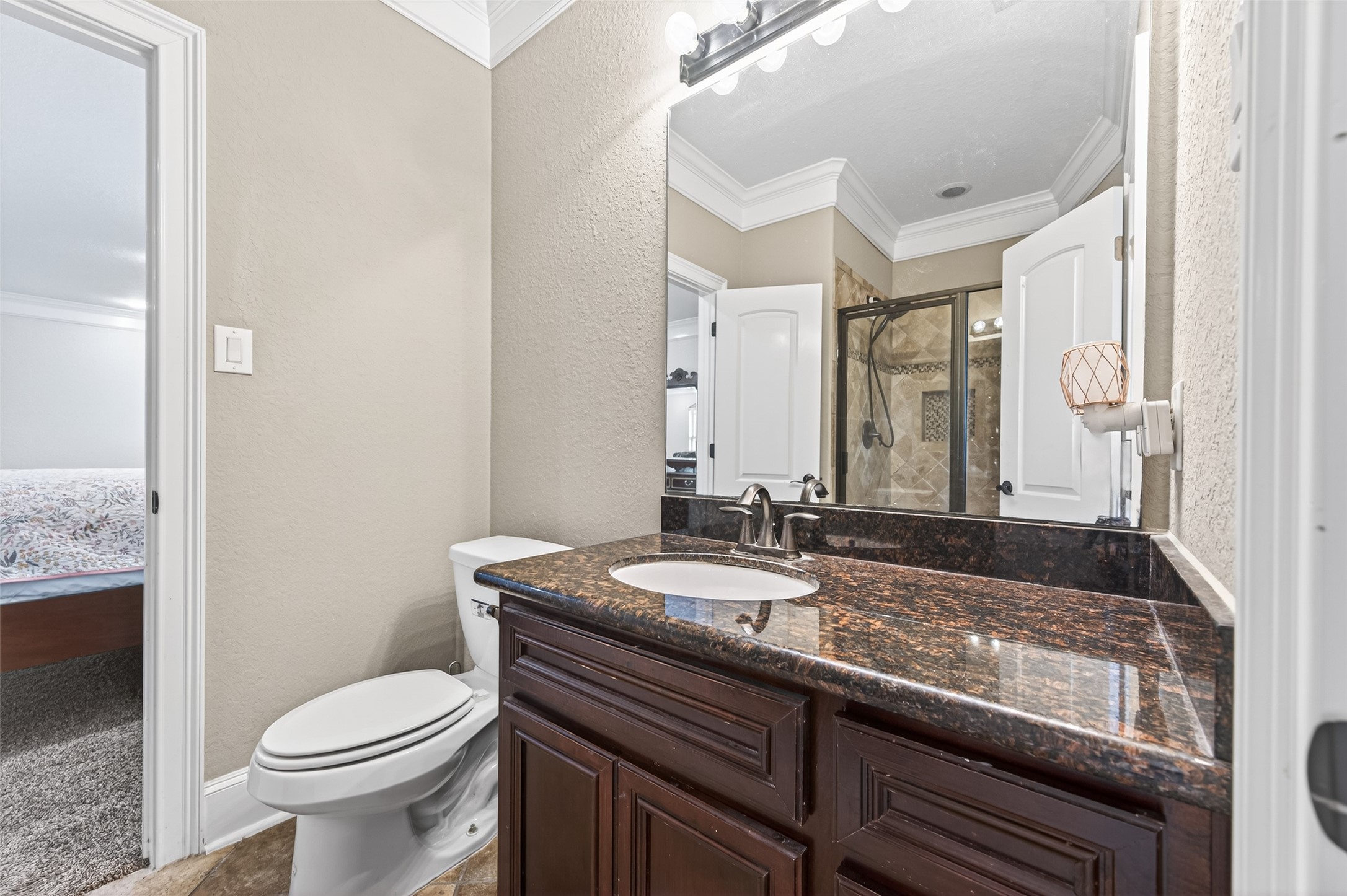 633 Crenshaw Road Houston, TX 77504 - Photo 38 of 50 a bathroom with a granite countertop toilet sink and mirror