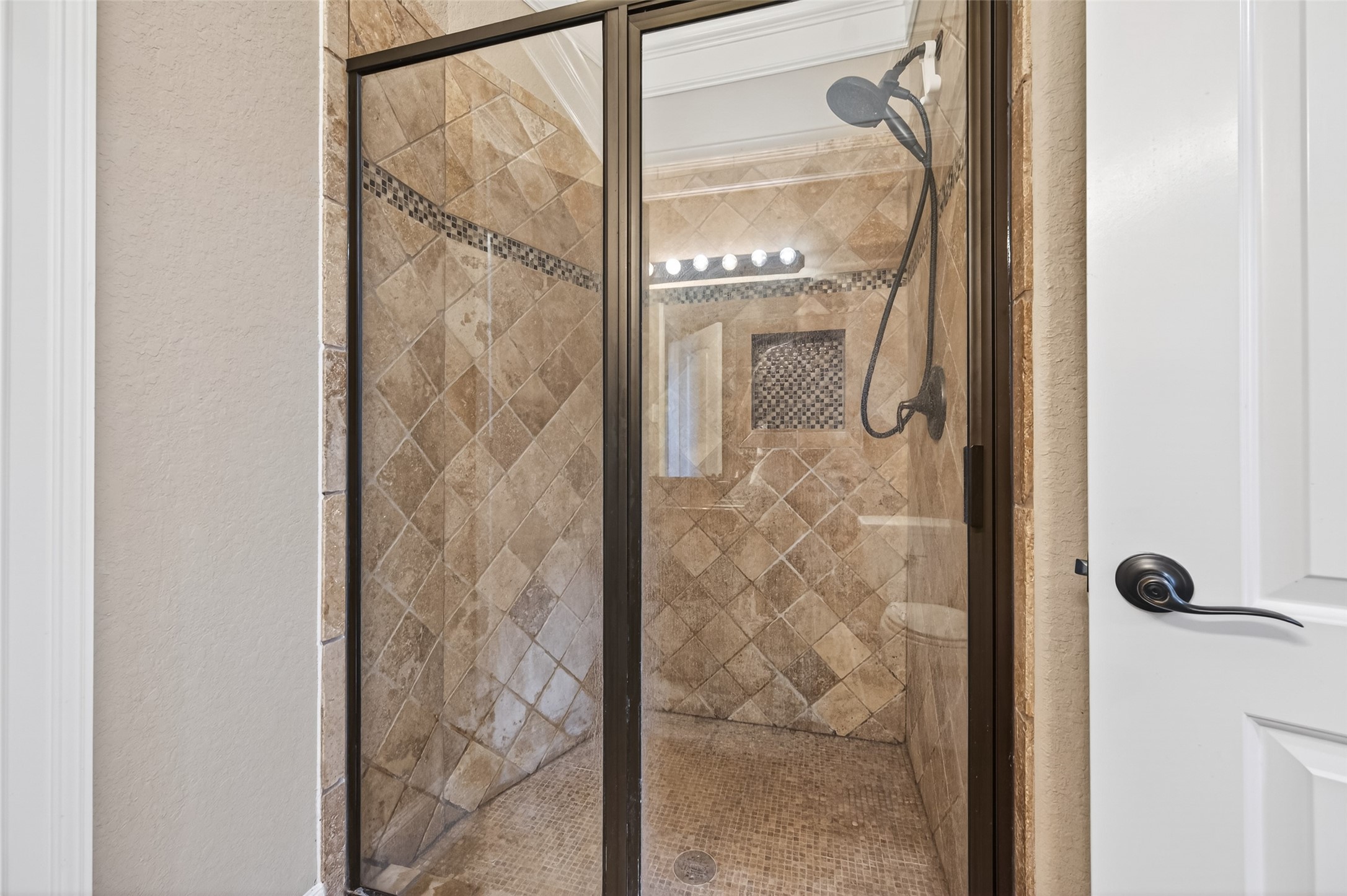 633 Crenshaw Road Houston, TX 77504 - Photo 39 of 50 a bathroom with a glass shower door and mirror