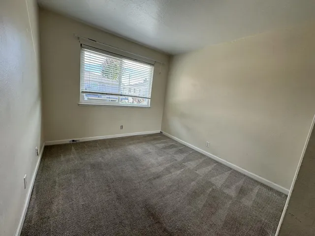 a view of a hallway with wooden floor and glass door