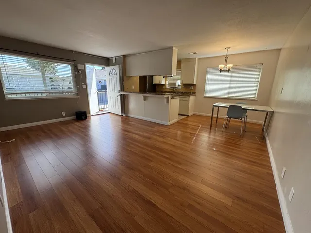 a view of kitchen with cabinets and wooden floor