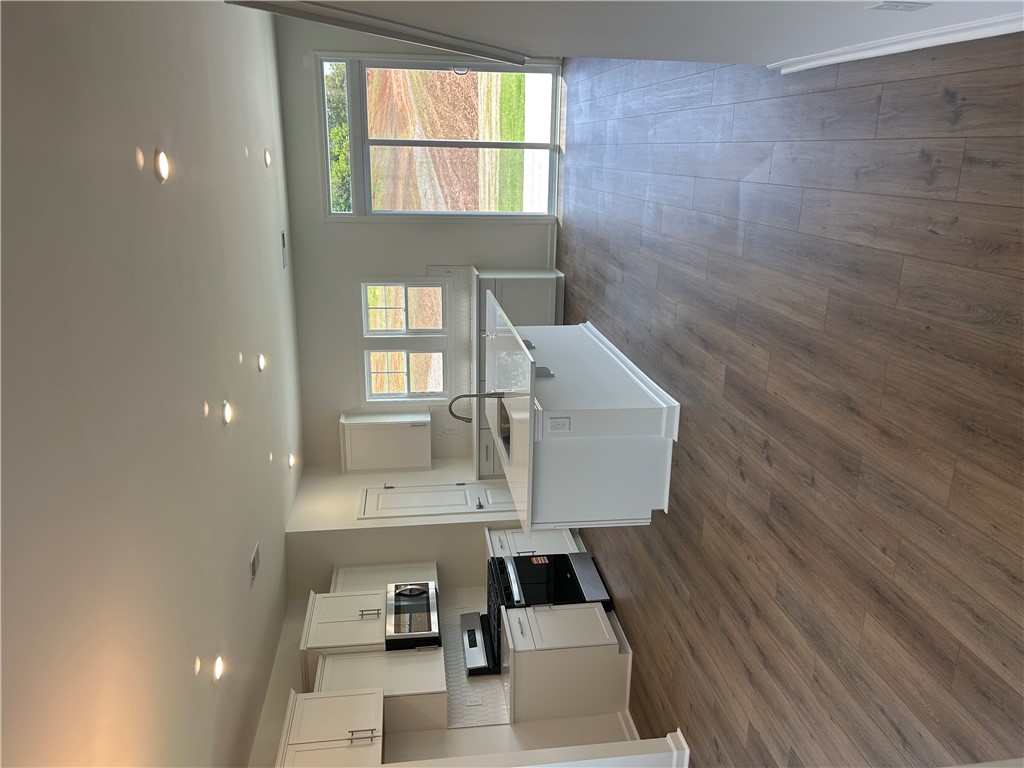 211 Bellflower Lane Anderson, SC 29625 - Photo 8 of 28 A contemporary kitchen space boasts gleaming hardwood floors and ample natural light.