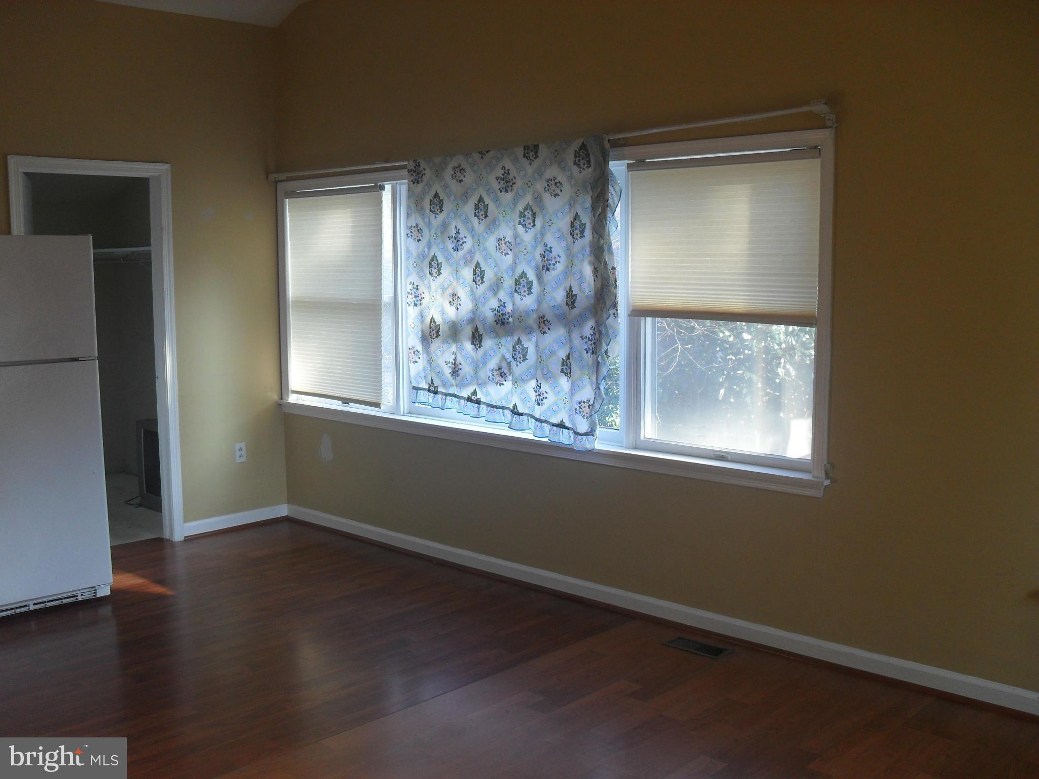 2014 Evans Parkway Silver Spring, MD 20902 - Photo 5 of 8 an empty room with wooden floor and windows