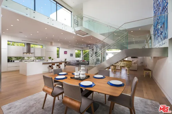 a view of a dining room with furniture wooden floor and a rug