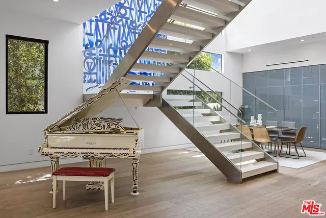 a view of a living room and dining room with furniture one side kitchen