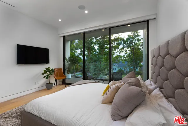 a view of a porch with chairs and potted plants