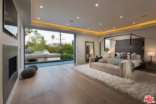 a living room with furniture and a floor to ceiling window