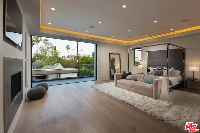 a living room with furniture and a floor to ceiling window