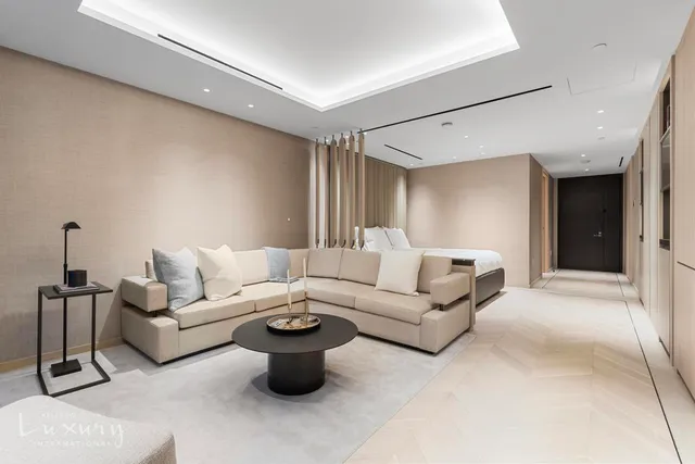 a living room with furniture a lamp and a rug