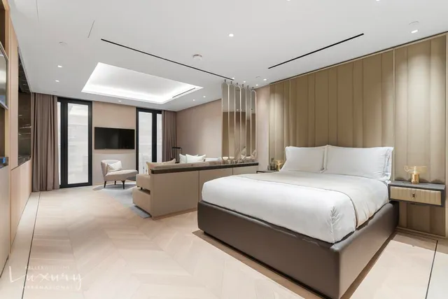 a large bedroom with a large bed and a large window