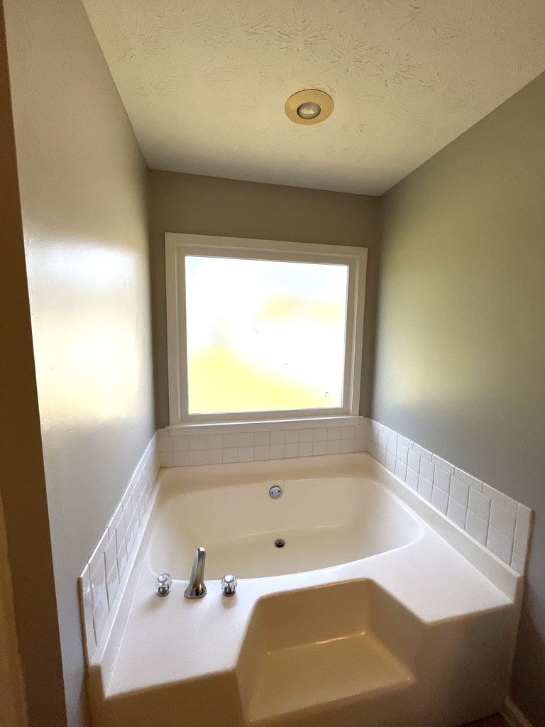 7289 Midland Chase Loop Columbus, GA 31909 - Photo 11 of 19 a bath tub sitting in a bathroom next to a window