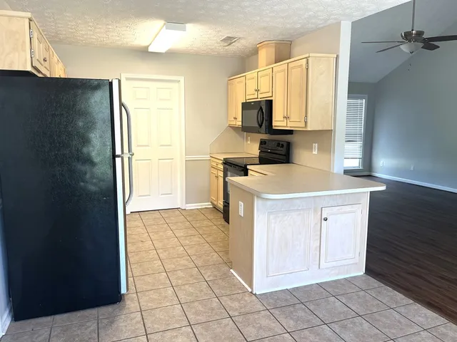 a kitchen with stainless steel appliances a refrigerator sink and cabinets