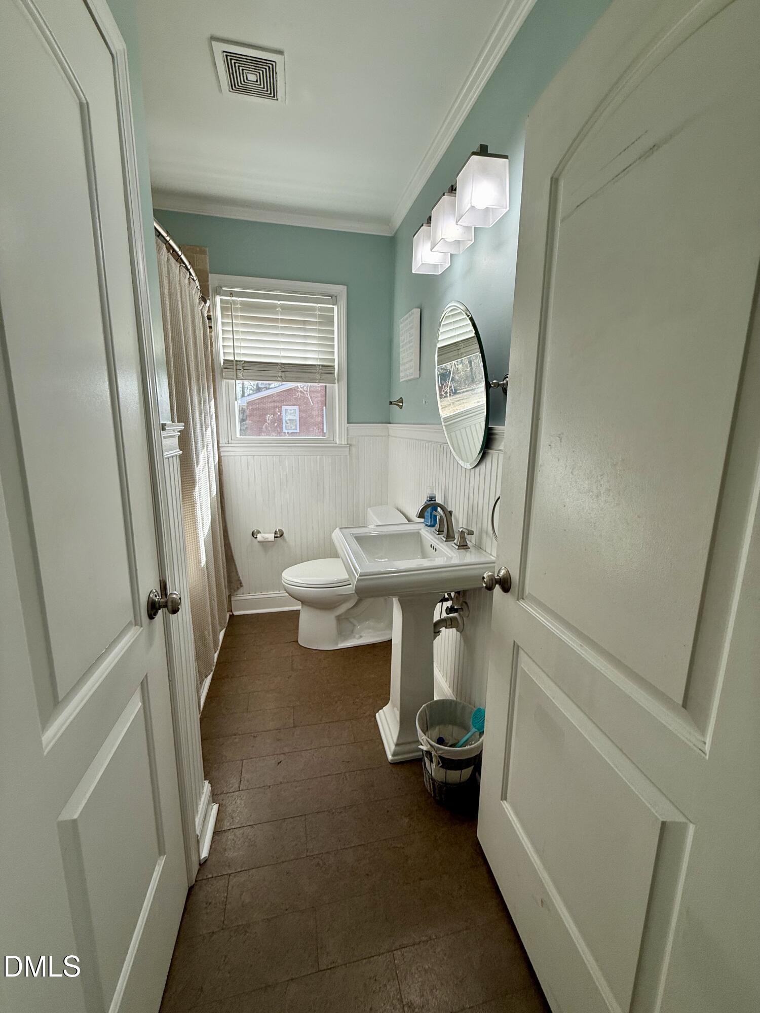 1689 Amelia Church Road Clayton, NC 27520 - Photo 14 of 23 a bathroom with a toilet a sink and a mirror
