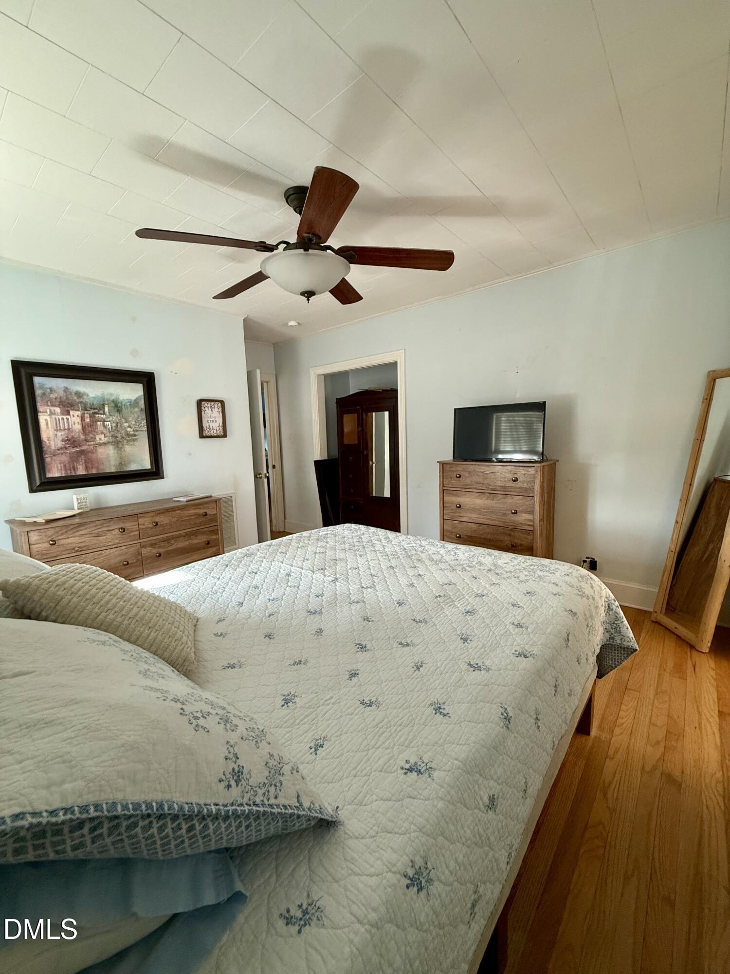 1689 Amelia Church Road Clayton, NC 27520 - Photo 17 of 23 a bedroom with a large bed and a chandelier