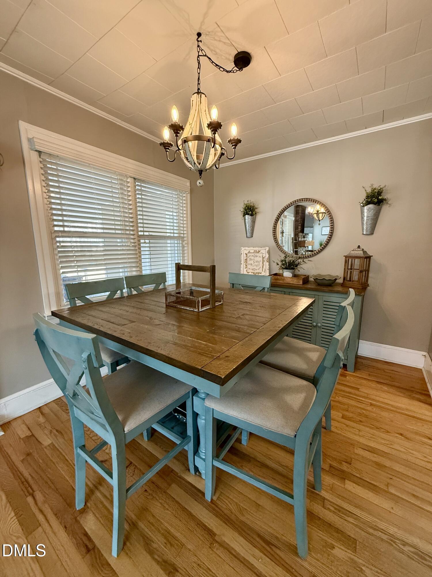 1689 Amelia Church Road Clayton, NC 27520 - Photo 8 of 23 a view of a dining room with furniture and a chandelier