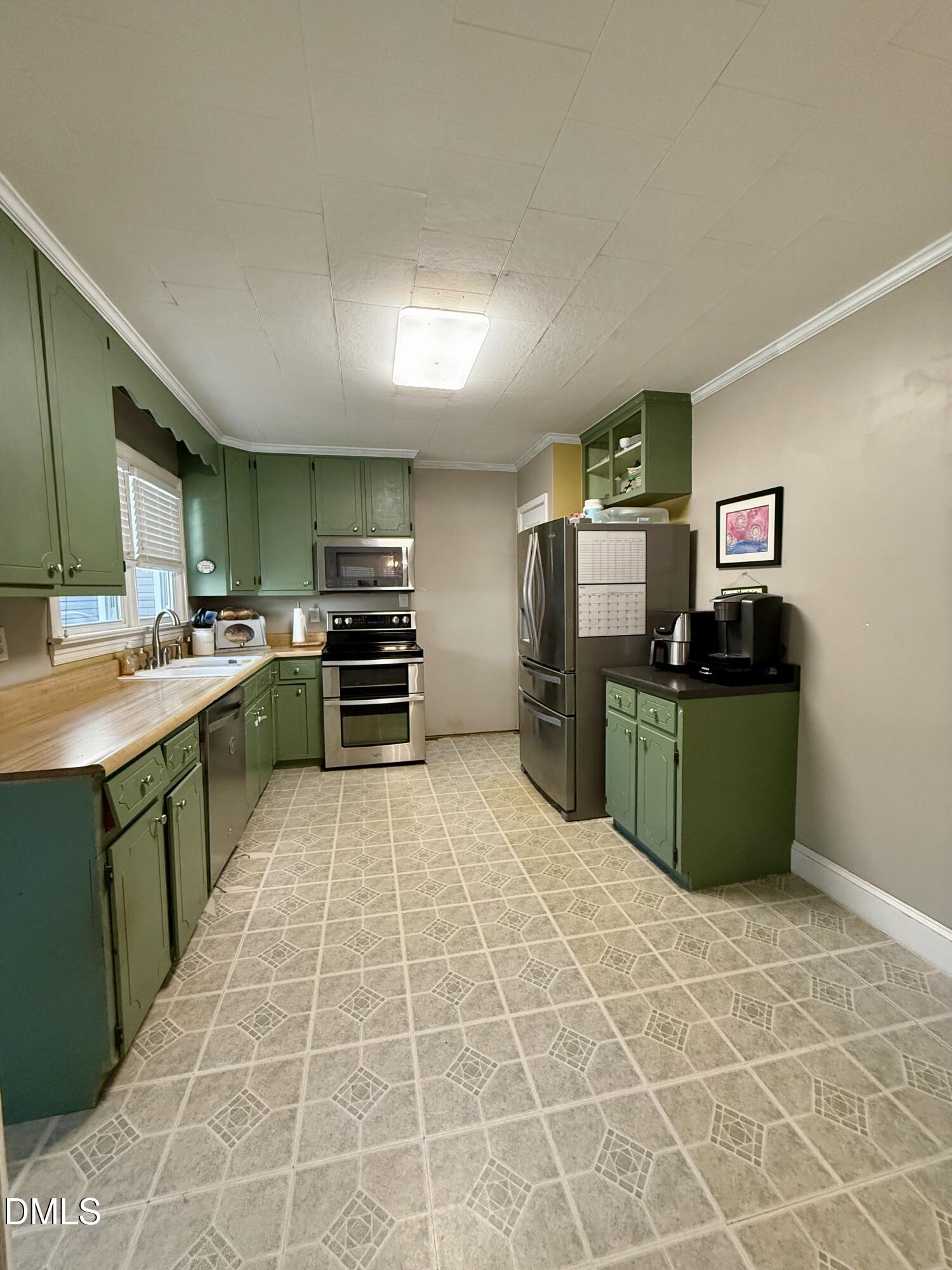 1689 Amelia Church Road Clayton, NC 27520 - Photo 9 of 23 a kitchen with stainless steel appliances kitchen island granite countertop a sink and cabinets