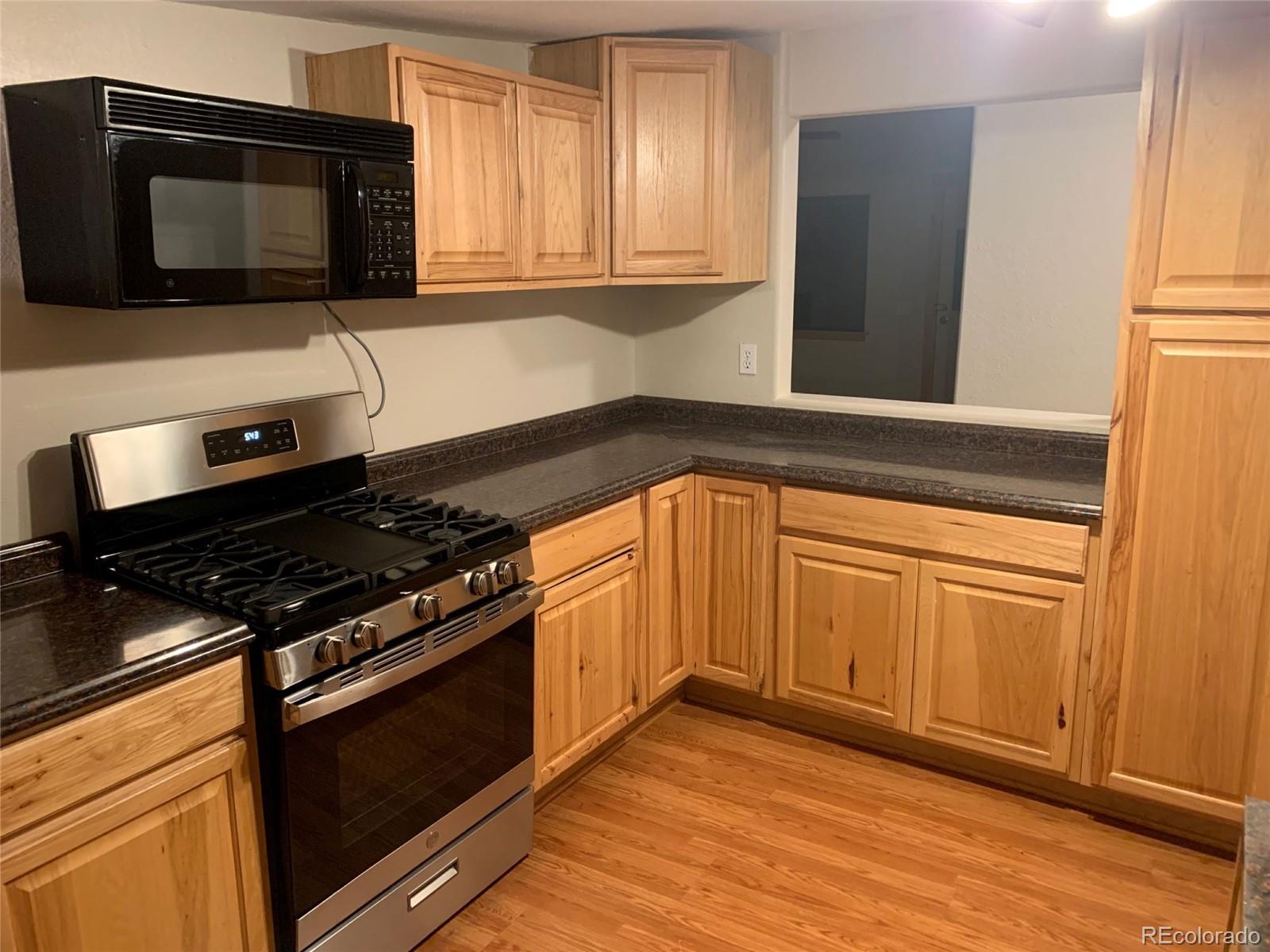 12 Fitzsimmons Road Bailey, CO 80421 - Photo 3 of 26 a kitchen with granite countertop cabinets stainless steel appliances and wooden floor