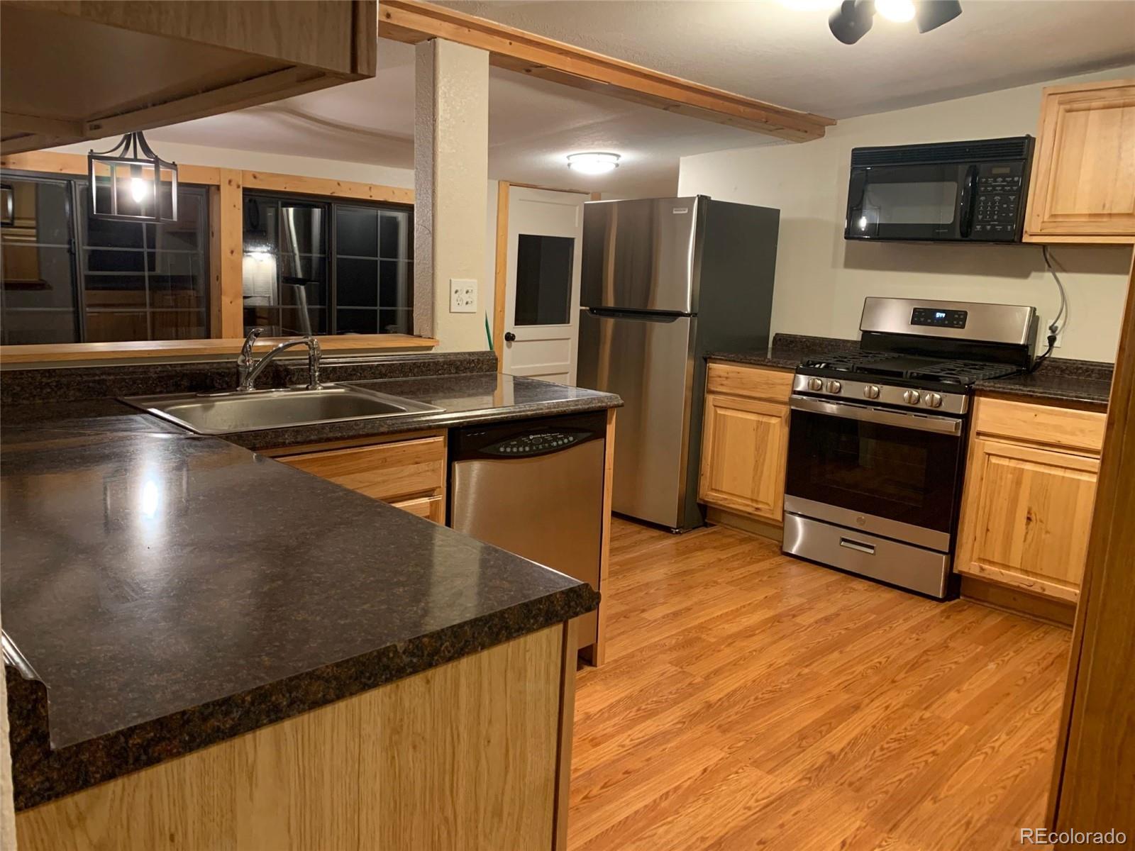 12 Fitzsimmons Road Bailey, CO 80421 - Photo 7 of 26 a kitchen with stainless steel appliances granite countertop a sink and a stove