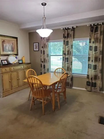 a view of a dining room with furniture window and outside view