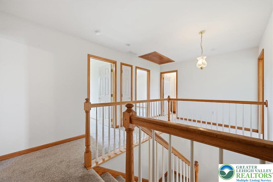 66 Labar Road Bangor, PA 18013 - Photo 20 of 56 A well-lit second-story landing features light wood banisters and carpeting, offering access to several rooms.