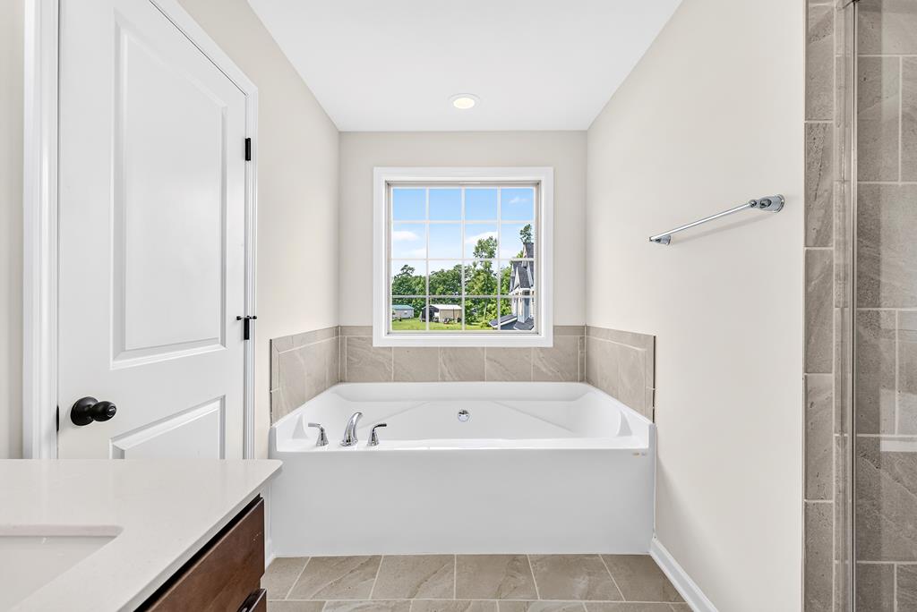 6 Liberty Place Fort Mitchell, AL 36856 - Photo 19 of 27 a white bath tub sitting in a bathroom next to a window