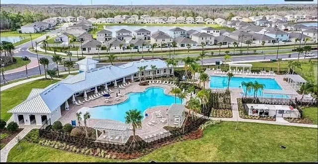 an aerial view of residential building and lake