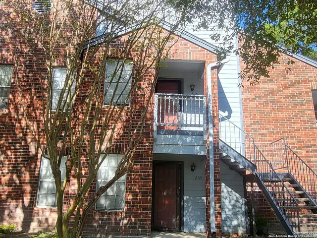 a view of house with a tree