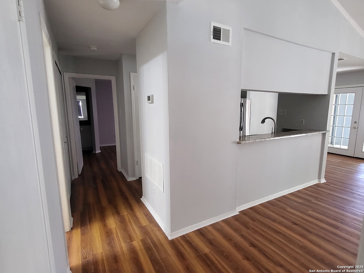 14343 Judson Road, Unit 206 San Antonio, TX 78233 - Photo 5 of 12 a view of a hallway with wooden floor and staircase