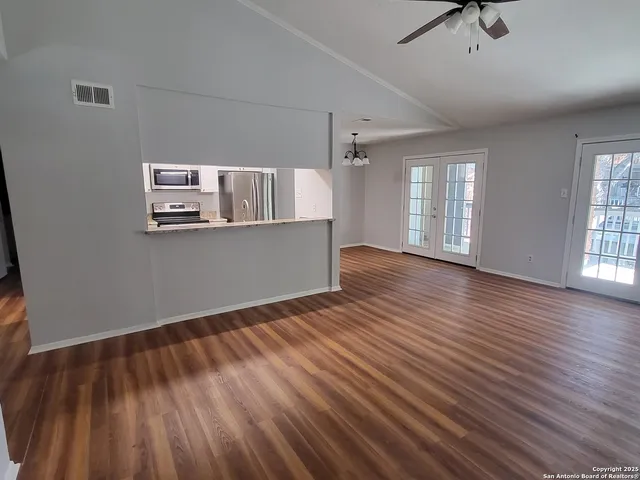 wooden floor in an empty room with a window