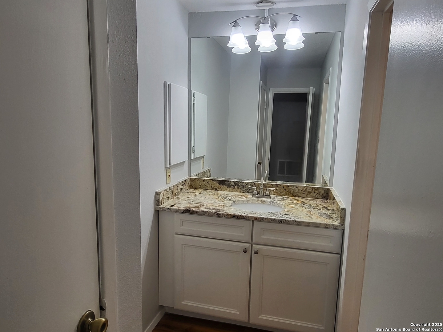 14343 Judson Road, Unit 206 San Antonio, TX 78233 - Photo 9 of 12 a bathroom with a granite countertop sink and a mirror