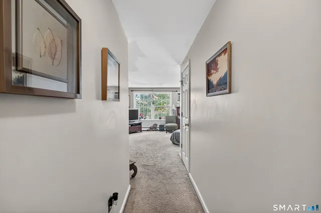 a bedroom with a bed dresser and a window