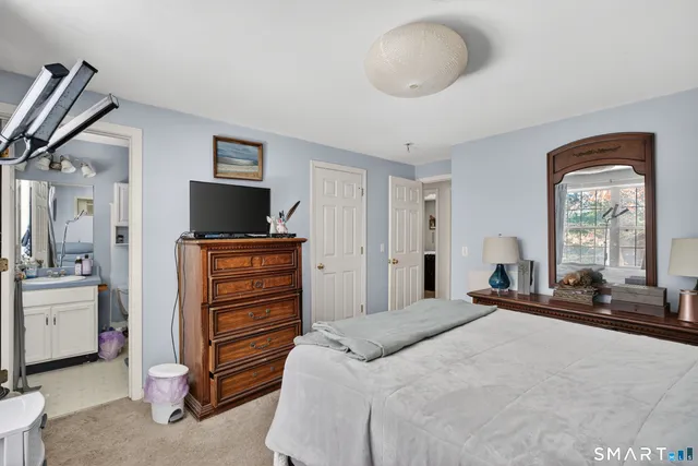 a bedroom with bed and a couch