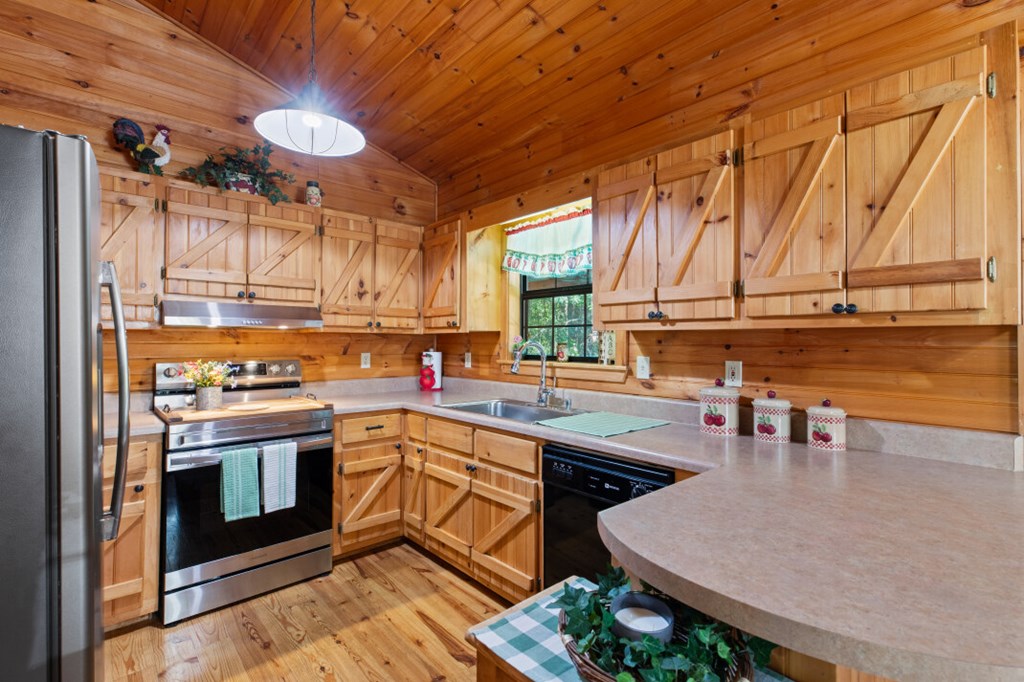 66 Fortenberry Road Young Harris, GA 30582 - Photo 9 of 55 a kitchen with a sink a stove and chairs