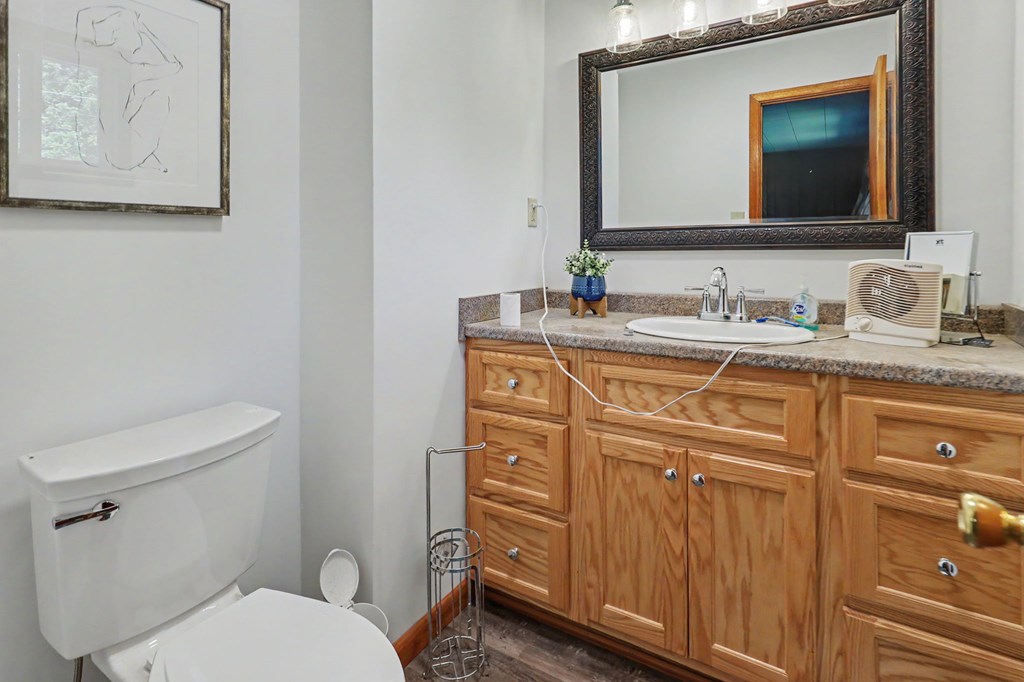 63 Fort Butler Street Murphy, NC 28906 - Photo 20 of 30 a bathroom with a granite countertop toilet sink and mirror