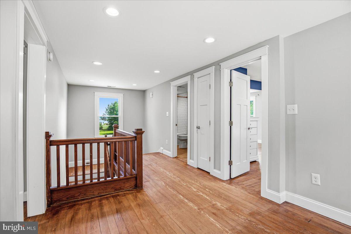 16146 Thomas Road Piney Point, MD 20674 - Photo 37 of 70 a view of hallway with wooden floor and windows