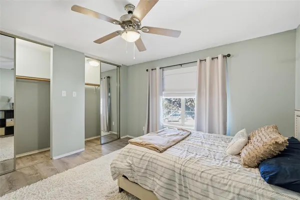 a bedroom with a large bed and a chandelier