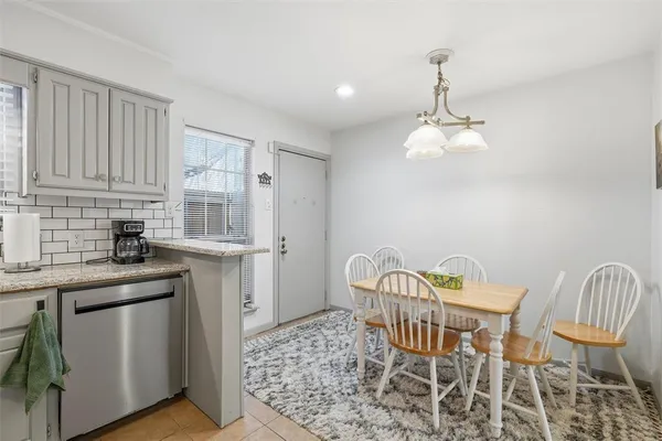 a view of a kitchen area with furniture and wooden floor