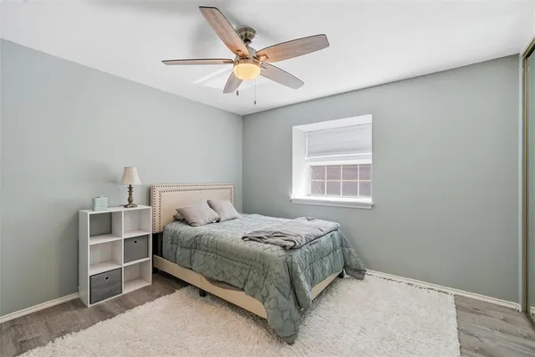 a bedroom with a bed and a ceiling fan