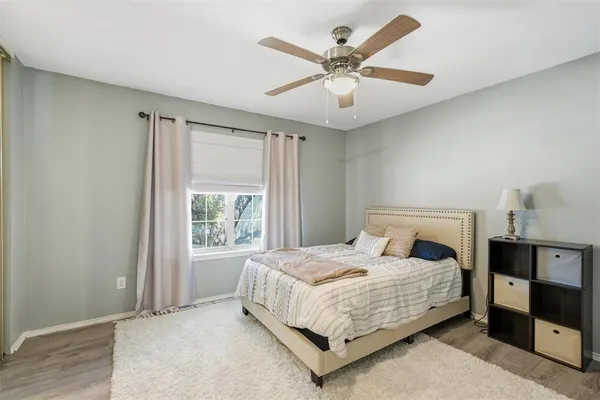 a bedroom with a large bed and a window