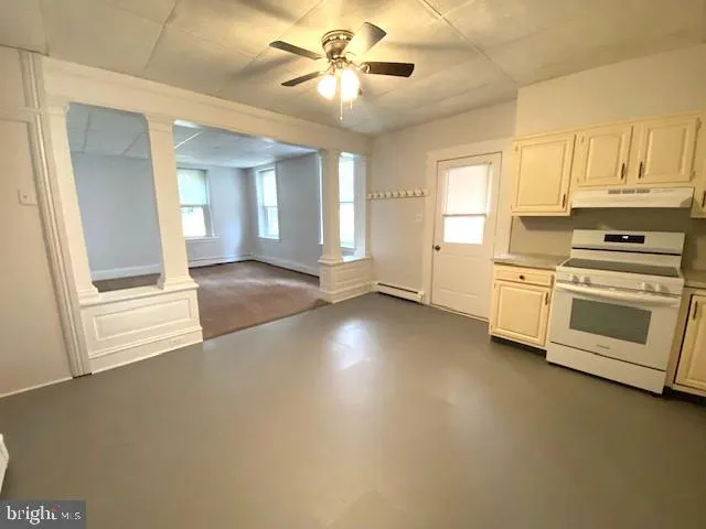 a view of a kitchen with a stove cabinets and a kitchen