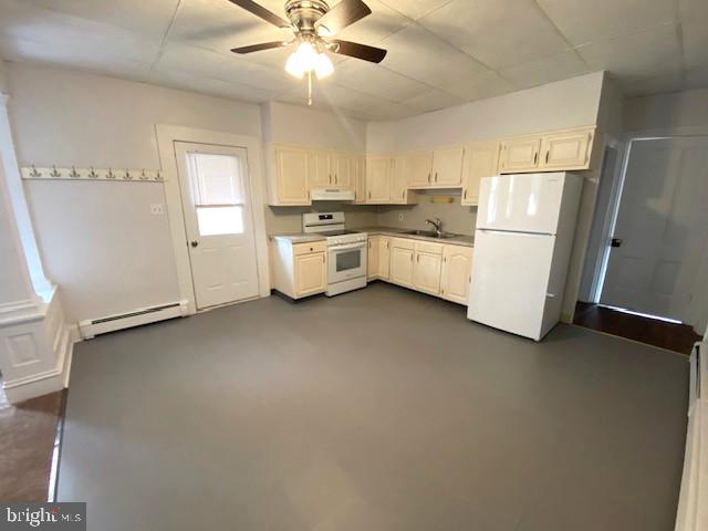 131 South 5th Street, Unit B Perkasie, PA 18944 - Photo 3 of 9 a white kitchen with stainless steel appliances a refrigerator a sink a stove top oven a counter space and cabinets