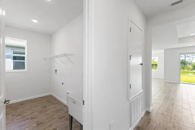 a view of hallway with wooden floor