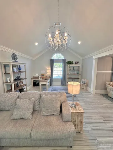 a living room with furniture and a chandelier