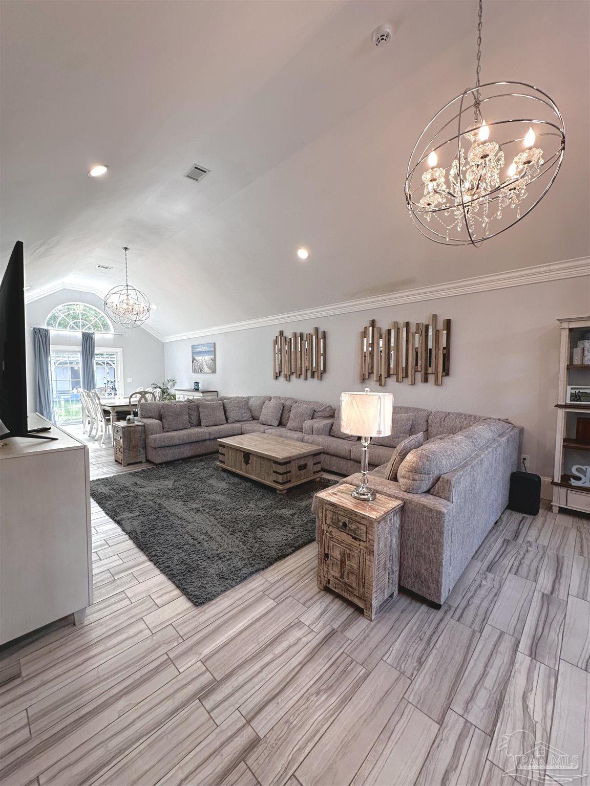 3097 Fayal Drive Pensacola, FL 32526 - Photo 12 of 46 a living room with furniture and a chandelier