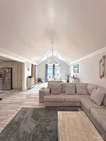 a living room with furniture chandelier and a chandelier