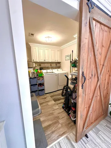 a room with wooden cabinets and chair