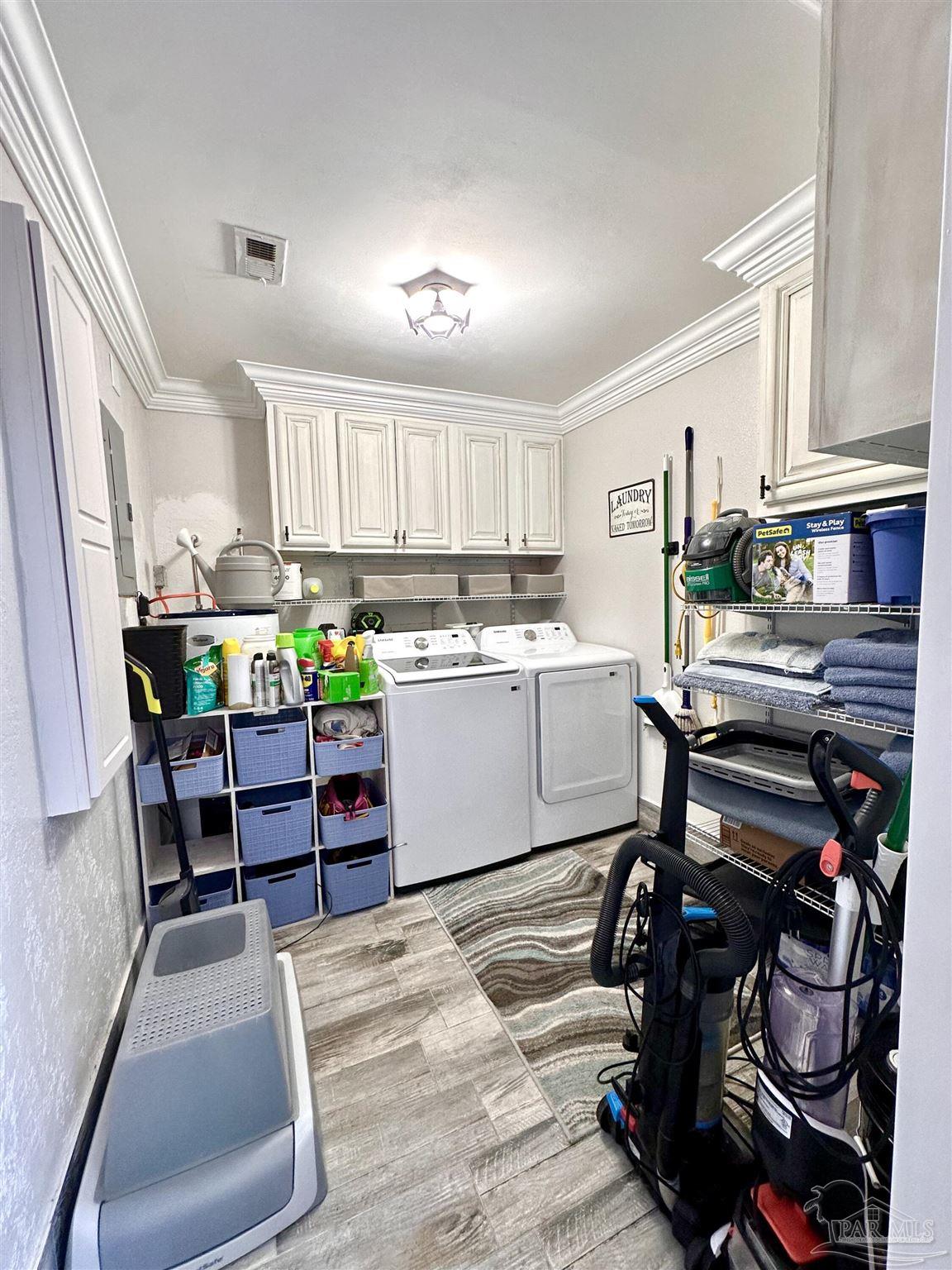 3097 Fayal Drive Pensacola, FL 32526 - Photo 19 of 46 a room with wooden cabinets and chair