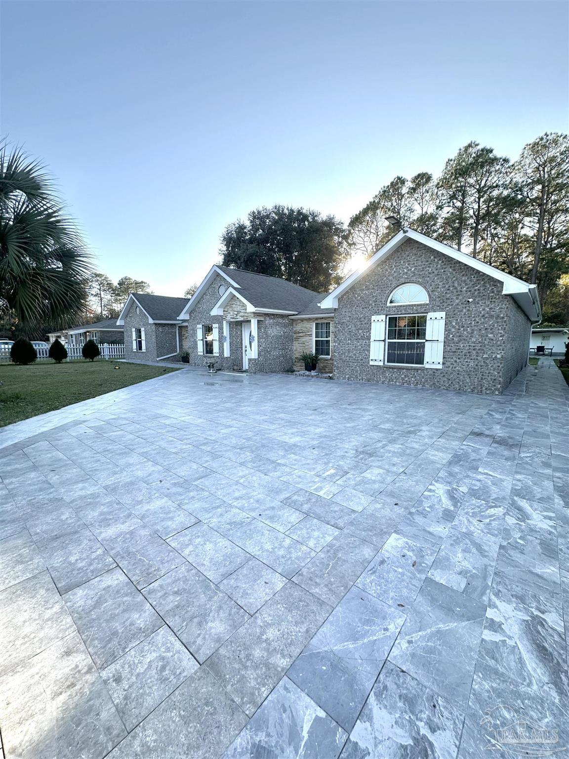 3097 Fayal Drive Pensacola, FL 32526 - Photo 2 of 46 a front view of a house with a yard and garage